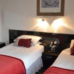 Twin or Double en-suite Twin or Double en-suite room with large window overlooking free parking bays to the side of the guest houes.