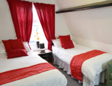Twin en-suite featuring full size bath tub, shower, sink and w.c.