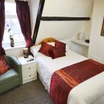 Double room with own private shower (but not en-suite), overlooking the free parking bays to the west of the Guest House. Single supplement available on this room.